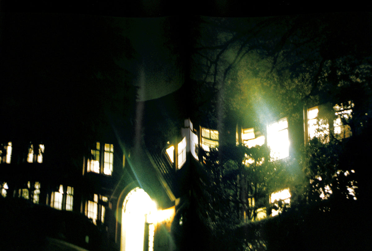 Interior page of HIROMIX / Hikari. Dark, eerie scene of a building with glowing windows at night