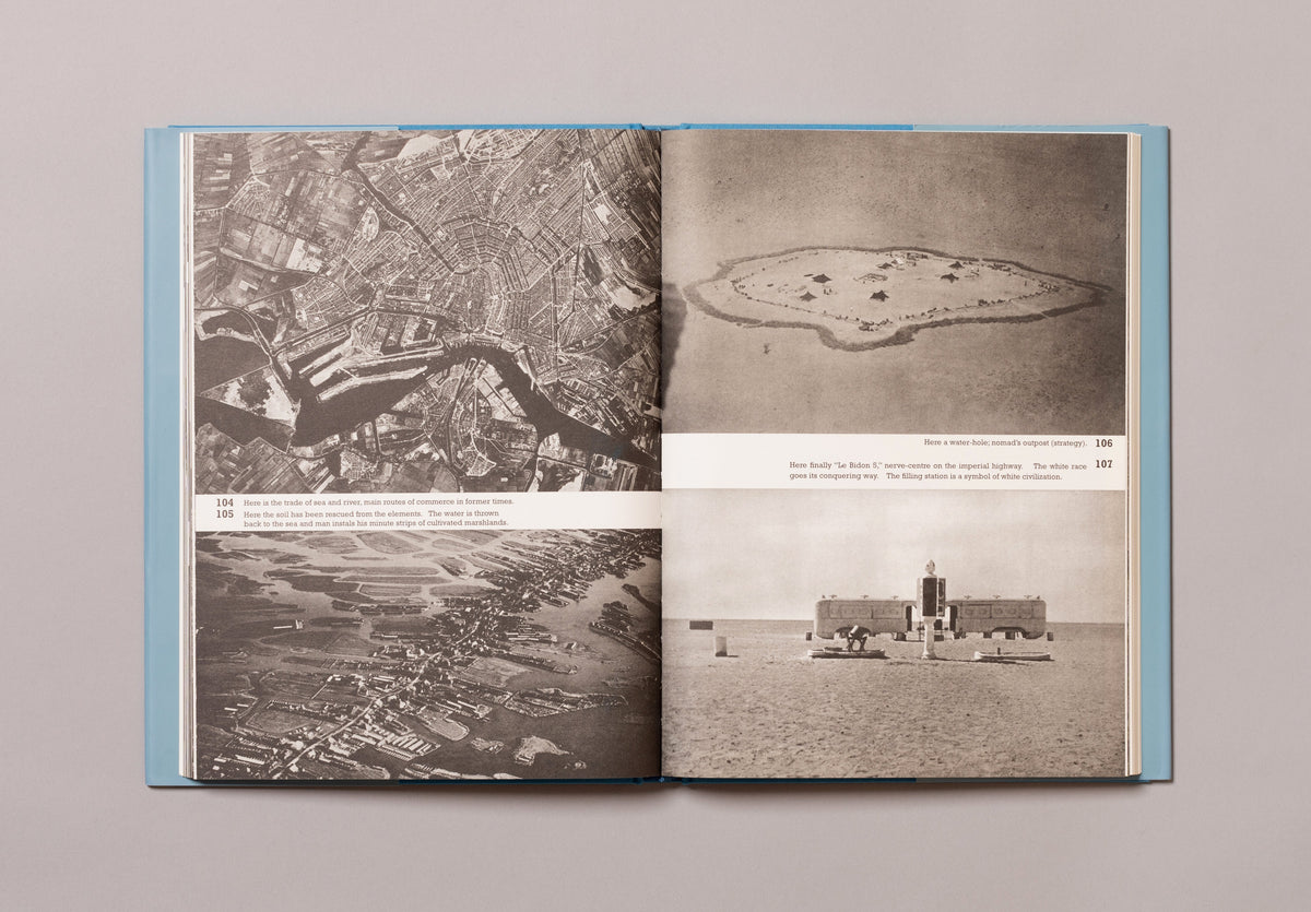 Open book showing black and white aerial photographs on a gray background