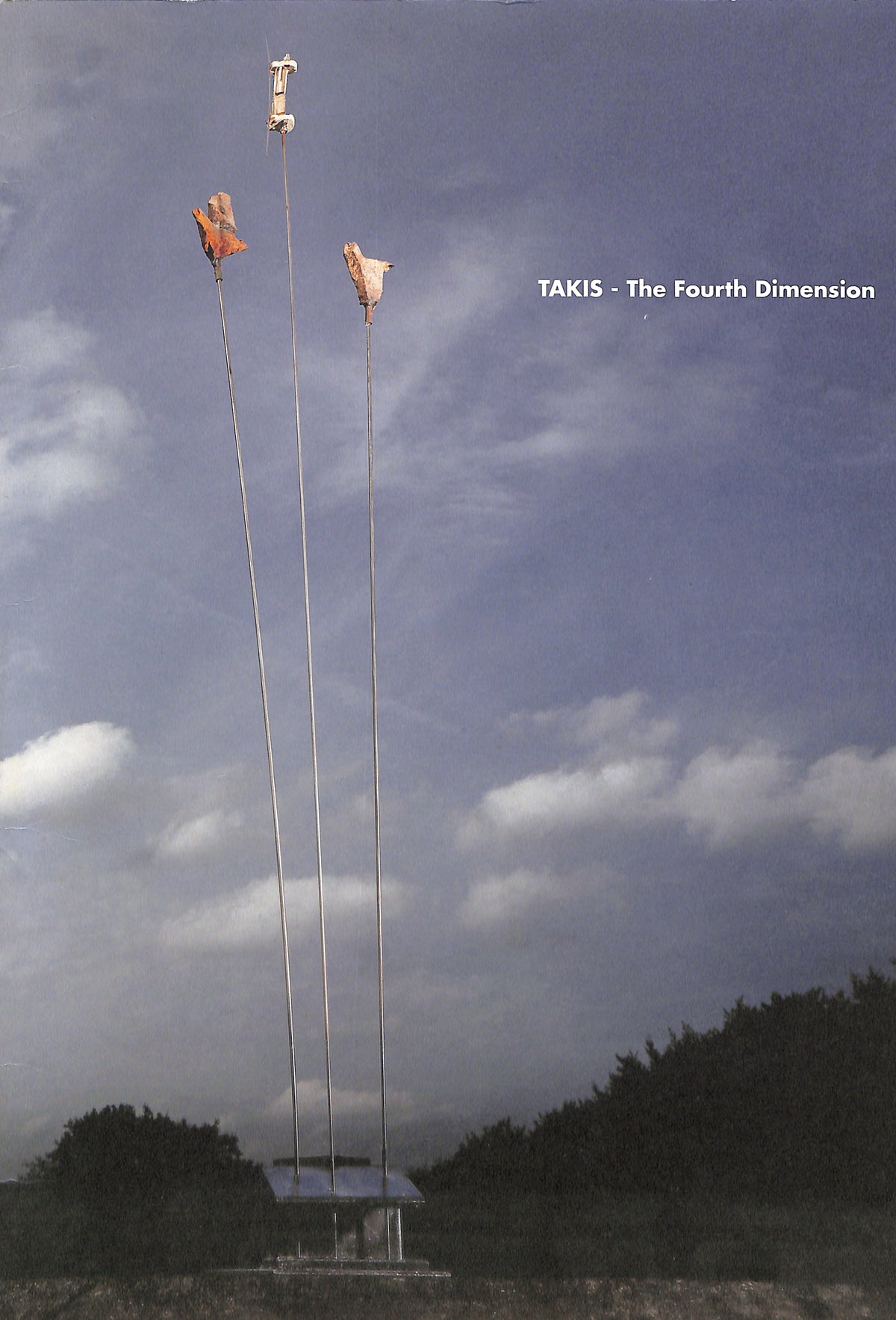 Cover of Takis the fourth dimension - Towers with sculptures against a cloudy sky, featuring the text 'Takis: The Fourth Dimension'.